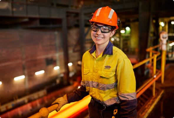 Young BlueScope employee standing on a platform in a manufacturing facility